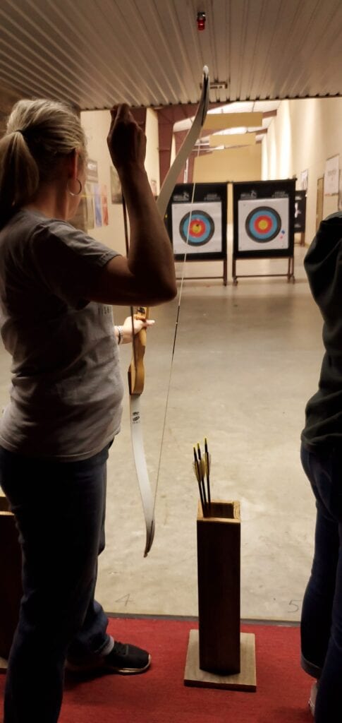 Kathy notching an arrow in her bow.