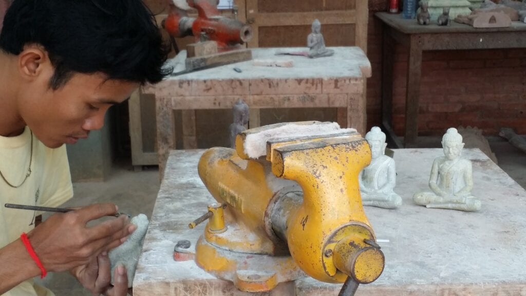 Young man carving at Artisans d'Angkor in Siem Reap, Cambodia